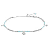 Cavigliera con ematite cubica alternata a perline conchiglia e stelle marine pendenti