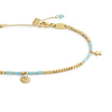 Cavigliera con ematite cubica alternata a perline conchiglia e stelle marine pendenti