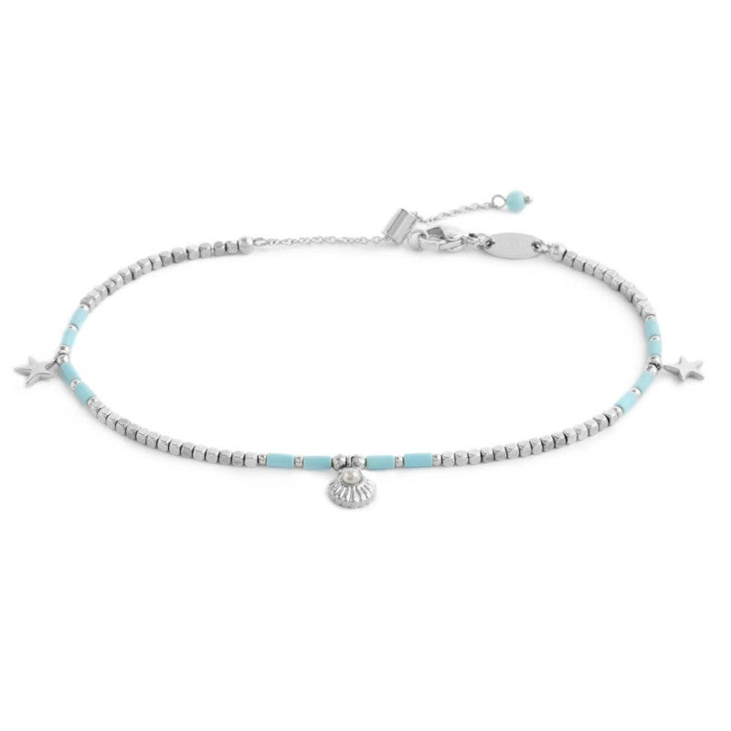 Cavigliera con ematite cubica alternata a perline conchiglia e stelle marine pendenti