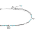 Cavigliera con ematite cubica alternata a perline conchiglia e stelle marine pendenti