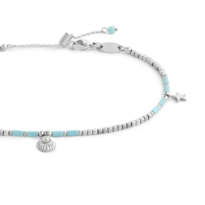 Cavigliera con ematite cubica alternata a perline conchiglia e stelle marine pendenti